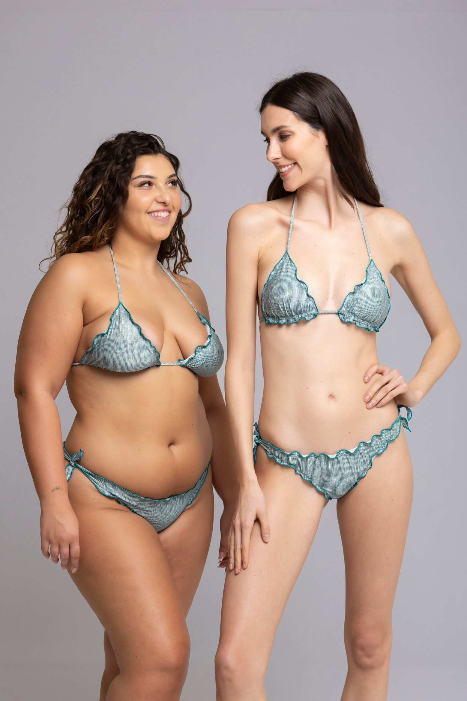 Models are wearing Fru Fru Lurex Pois Turquoise Bikini Set - front view - one in size small, one in size large