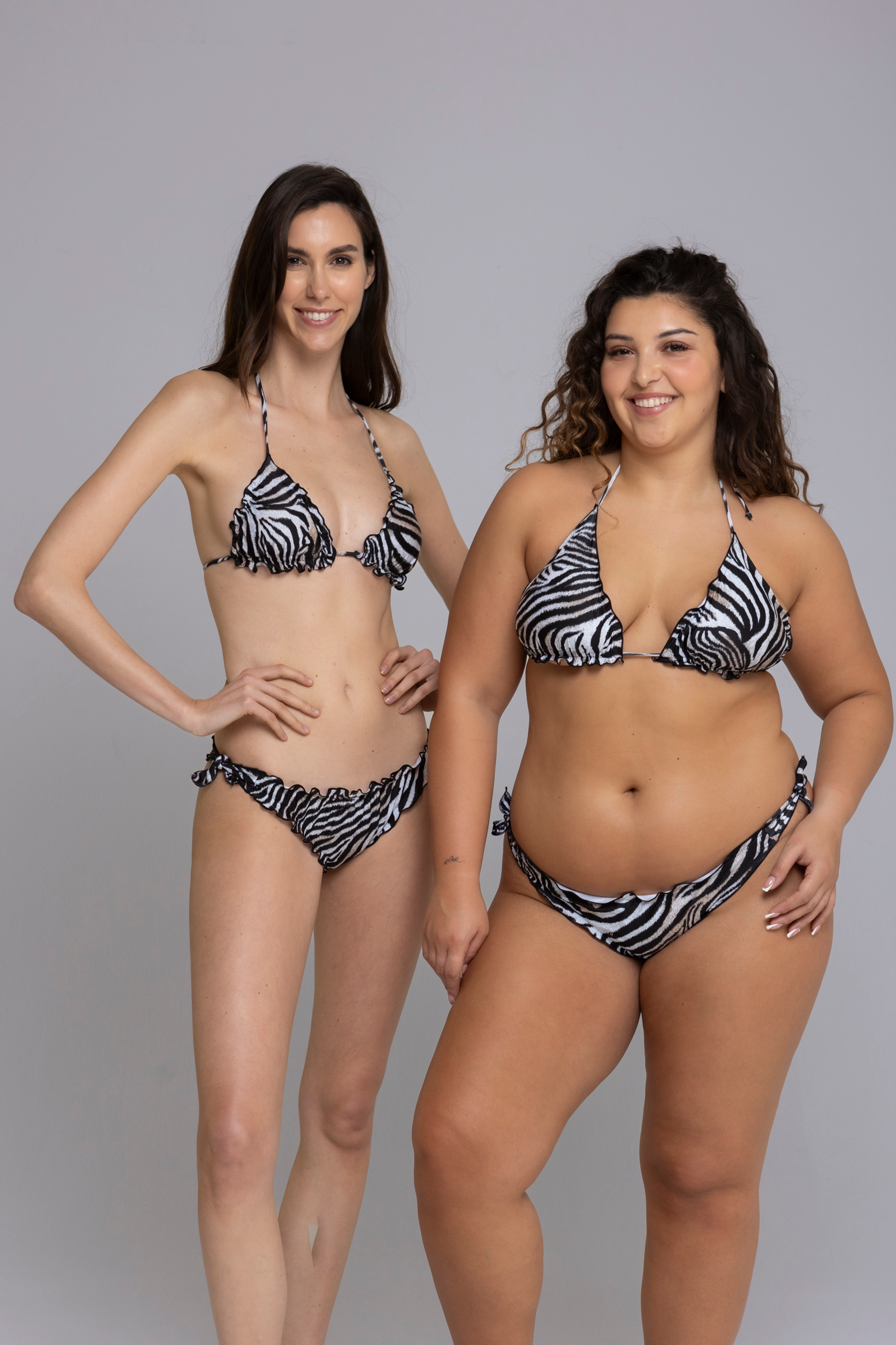 Two Model wearing Fru Fru Zebra Print Triangle Bikini Set - front view - one in size small, one in size large.