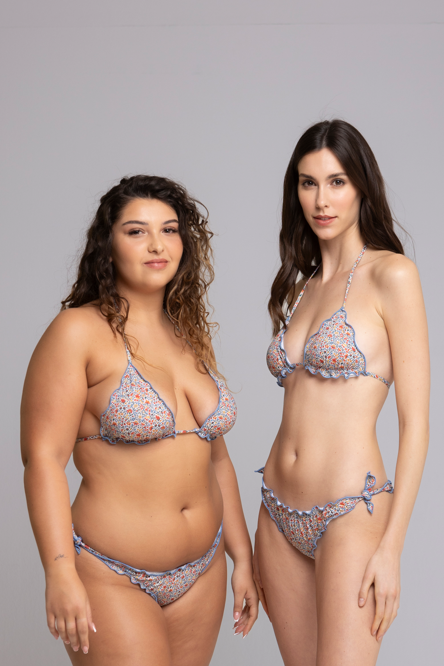 models are wearing Fru Fru Blue Floral Fantasy Triangle Bikini Set - front view - one in size small, one in size large